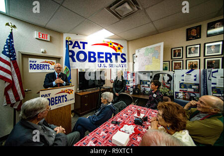 Overland Park, Kansas, USA, October 12, 2014 Senator Pat Roberts addresses supporters at his campaign office in Overland Park today. Then he served them a quick barbecue lunch before going on to the Turner Day festival at Steineger field in the Turner community. With the Senator is his wife Franki the woman with the white blond hair. Who is usually close enough to hold hands with the Senator. Stock Photo