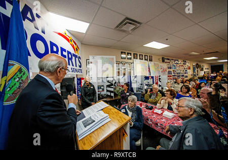 Overland Park, Kansas, USA, October 12, 2014 Senator Pat Roberts addresses supporters at his campaign office in Overland Park today. Then he served them a quick barbecue lunch before going on to the Turner Day festival at Steineger field in the Turner community. With the Senator is his wife Franki the woman with the white blond hair. Who is usually close enough to hold hands with the Senator. Stock Photo