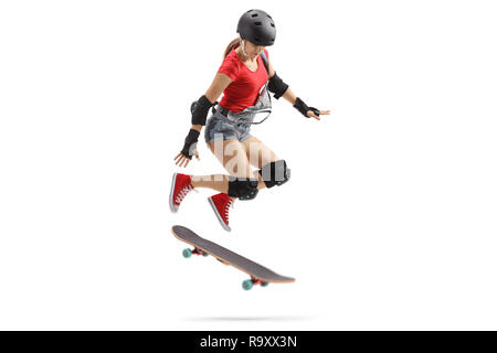 Full length shot of a female jumping with a skateboard isolated on white background Stock Photo