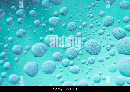 Abstract - oil mixed in water on a grey and blue background. Photographed in close up with shallow DOF. Photo taken:  November 12, 2018 Stock Photo