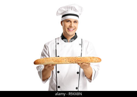 Young male baker holding a freshly baked baguette bread isolated on white background Stock Photo