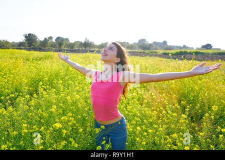 open arms happy teen girl in spring meadow brunette Stock Photo