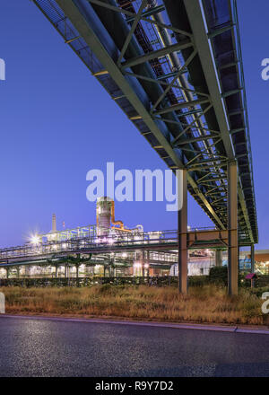 Illuminated petrochemical production plant at twilight, Port of Antwerp, Belgium. Stock Photo