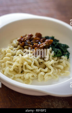 noodles in a bowl on a table close up photo