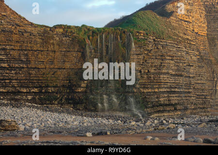 What is known locally as the "Magic waterfall" a seasonal flow of water from the local fields gathers in a small valley on its way to the sea. Stock Photo