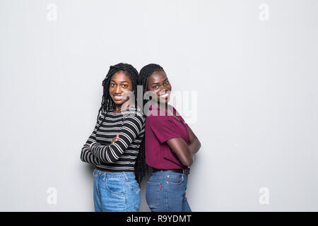 African two women standing back to back not speaking to each other on white Stock Photo