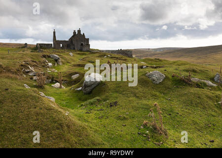 Ruins of an old manor with the remains of a broch in front on Shetland, Yell
