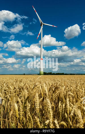 Wind Turbine in farmland under azure blue sky with cumulus cloud formation, Hesse, Germany Stock Photo