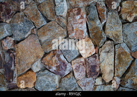 Texture of fragment of a wall from a chipped stone Stock Photo