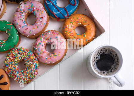 Colorful Donuts with Coffee in White Backdrop Stock Photo