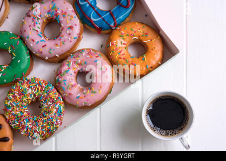 Colorful Donuts with Coffee in White Backdrop Stock Photo