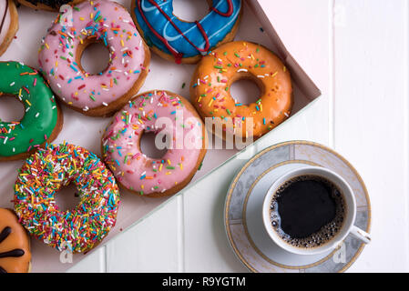 Colorful Donuts with Coffee in White Backdrop Stock Photo