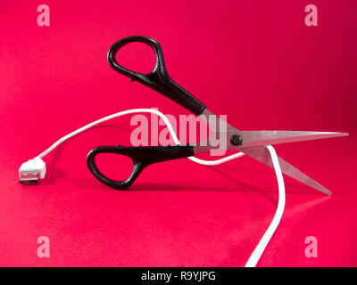cutting wire with scissors - tech, internet, information and communication styled concept, elegant visuals Stock Photo