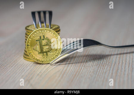 Bitcoin getting New Hard Fork Change, Physical Golden Crytocurrency Coin with fork, Blockchain concept Stock Photo