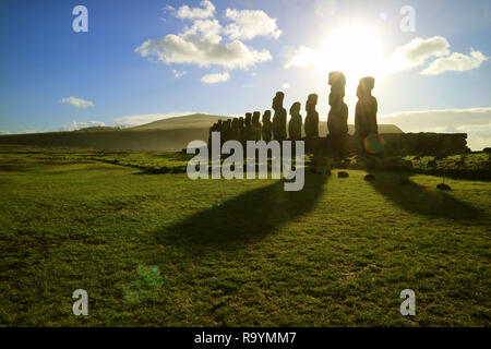 Silhouette of Moai statues against dazzling sunrise sky at Ahu Tongariki, the largest celemonial platform on Easter Island, Chile, South America Stock Photo