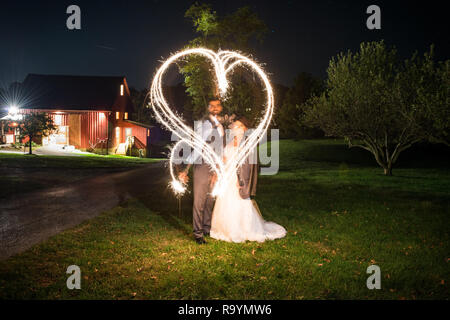 Creative long exposure light painting with bride and groom portraits after a wedding reception. Stock Photo