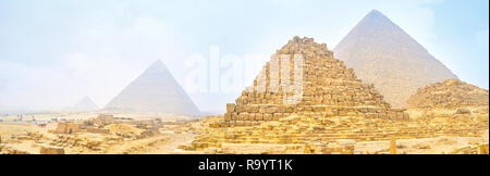 Panoramic view on Giza pyramids through heavy winter morning fog and sandy clouds, Egypt Stock Photo