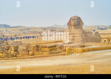 GIZA, EGYPT - DECEMBER 20, 2017: The crowds of tourists at the Sphinx viewing terrace in Giza archaeological site during winter foggy season, on Decem Stock Photo