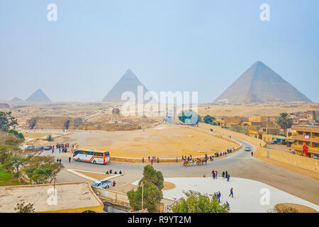 GIZA, EGYPT - DECEMBER 20, 2017: Panorama of Giza Necropolis with its iconic landmarks - Great Pyramids and Sphinx, built in desert, on December 20 in Stock Photo