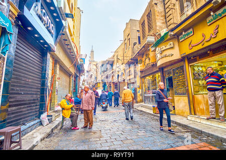 CAIRO, EGYPT - DECEMBER 20, 2017: The activity at goldsmith district of Khan El-Khalili Souq with merchants that stand at the entrance and invite clie