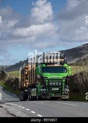 Articulated lorry transporting timber down a rural road, North Yorkshire, UK. Stock Photo