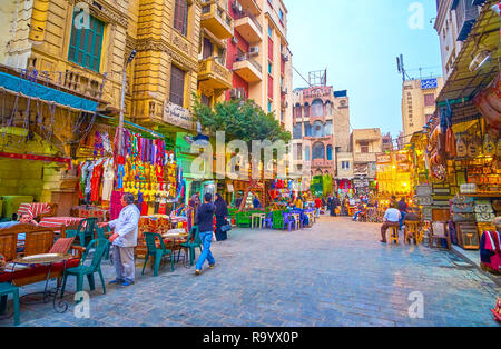 CAIRO, EGYPT - DECEMBER 20, 2017: The wide street with traditional Egyptian restaurants in Khan EL-Khalili Souq that alternate with souvenir and cloth Stock Photo