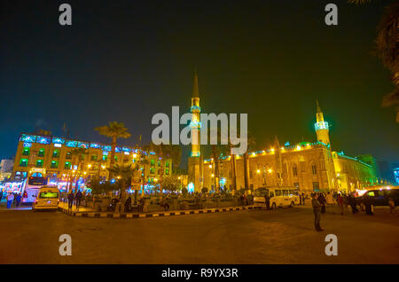 CAIRO, EGYPT - DECEMBER 20, 2017: Midan Hussein Square with illuminated Al-Hussein Mosque and neighbor edifices and spontaneous market are very crowde Stock Photo
