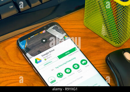 PIATRA NEAMT, ROMANIA - JULY 30, 2018: Samsung S8+ with Google Play store, Google Drive  application, office background. Stock Photo