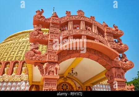 The stunning architecture of the temple of Sitagu International Buddhist Academy with terracotta torana gate, decorated with carved details, Sagaing,  Stock Photo