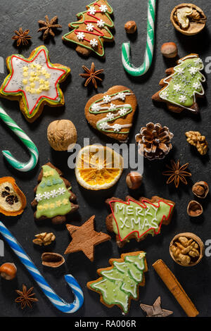 variety of christmas food products ginger cake nuts cinnamon stick lollipop Stock Photo