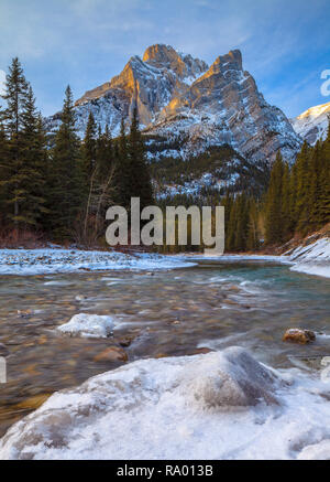 Mount Kidd, a mountain in Kananaskis in the Canadian Rocky Mountains, Alberta, Canada and the Kananaskis River in winter Stock Photo