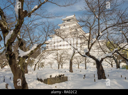 Winter scene in snow of Tsuruga Castle, a reconstruction of an Edo period castle viewed from the park Stock Photo