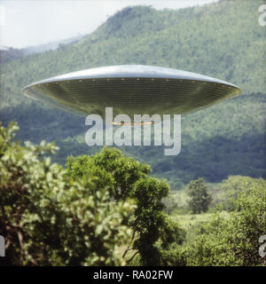 Unidentified flying object over a forest with trees and mountains behind. Stock Photo