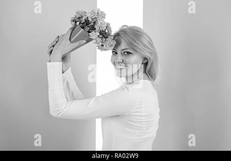 Her favorite flowers. Girl holding bouquet flowers enjoy favorite fragrance. Lady happy received favorite flowers as gift. Bouquet equal happiness. Woman smiling likes to receive bouquet surprise. Stock Photo