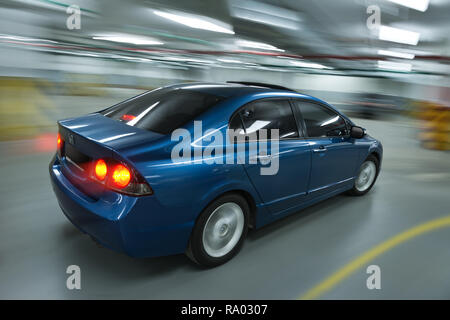 Blue honda civic in motion on parking lot Stock Photo