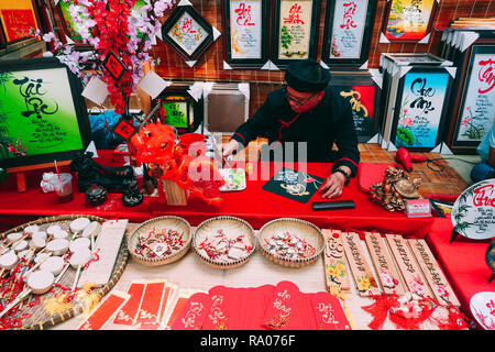 Vietnamese scholar writes calligraphy at lunar new year. Calligraphy festival is a popular tradition during Tet holiday. Culture of Vietnamese Tet Stock Photo