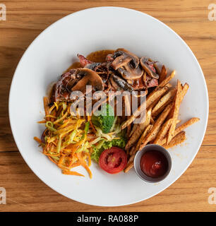 Gourmet Meatloaf with Wine Gravy, Vegetables and Hand Cut Fried Potatos Stock Photo