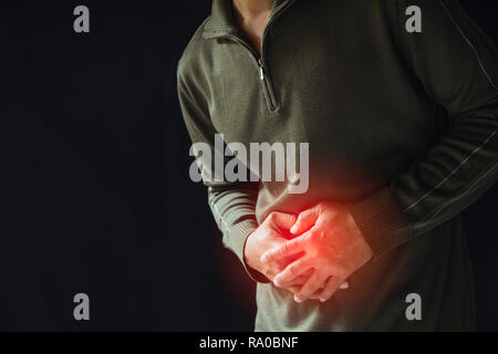 Male suffering from stomachache pain. A man stomachache. Healthy concept. Stock Photo