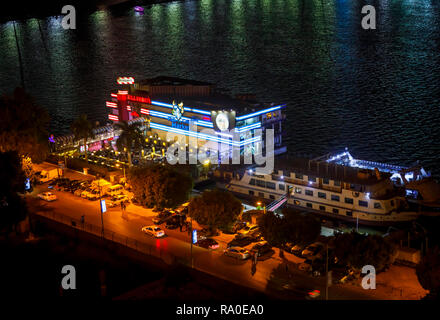 Floating restaurants, TGI Fridays, Grand Cafe and Fish Market, on boats moored on the River Nile, Giza, Cairo, Egypt, at night Stock Photo