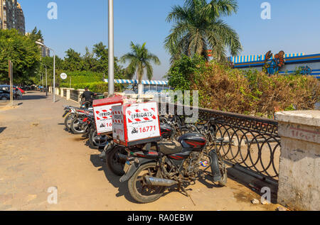 TGI Fridays restaurant delivery motorbikes parked by the roadside on a sunny day in Giza, Cairo, Egypt Stock Photo