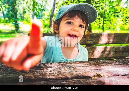 naughty boy child point finger at camera taunt portrait nature b Stock Photo