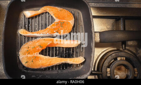 cooking raw salmon on the grill stove background horizontal Stock Photo
