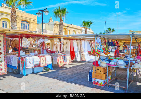 MARSAXLOKK, MALTA - JUNE 18, 2018: The stalls of the artisan market offers traditional embroidered pieces - tablecloths, decorative napkins, towels, s Stock Photo