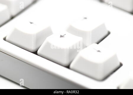 Modern computer keyboard. some part of white computer keyboard with shallow focus, focus on "down arrow" Stock Photo