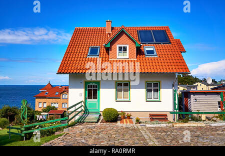 New modern single family house with red roof tiles and solar panels. Living overlooking the Baltic Sea in Lohme on the island of Rügen. Stock Photo