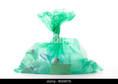 Green plastic bag with waste, isolated on white background, clipping path, excluding shadows, included Stock Photo