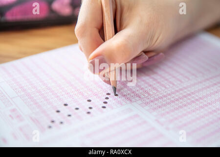 Pencil drawing selected choice on answer sheets. hand fill in Exam carbon paper computer sheet and pencil. Stock Photo