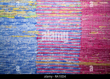 Texture of multi-colored homespun rug. Traditional rustic very long carpet with a striped pattern for use on a bench or floor Stock Photo