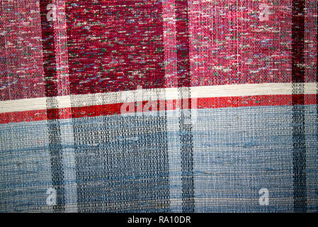 Texture of multi-colored homespun rug. Traditional rustic very long carpet with a striped pattern for use on a bench or floor Stock Photo
