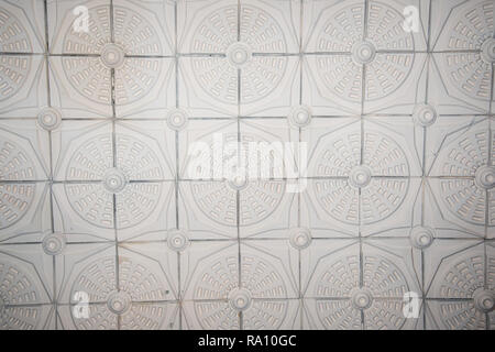 Old antique plaster ceiling with floral elements, gypsum ceiling tiles Stock Photo